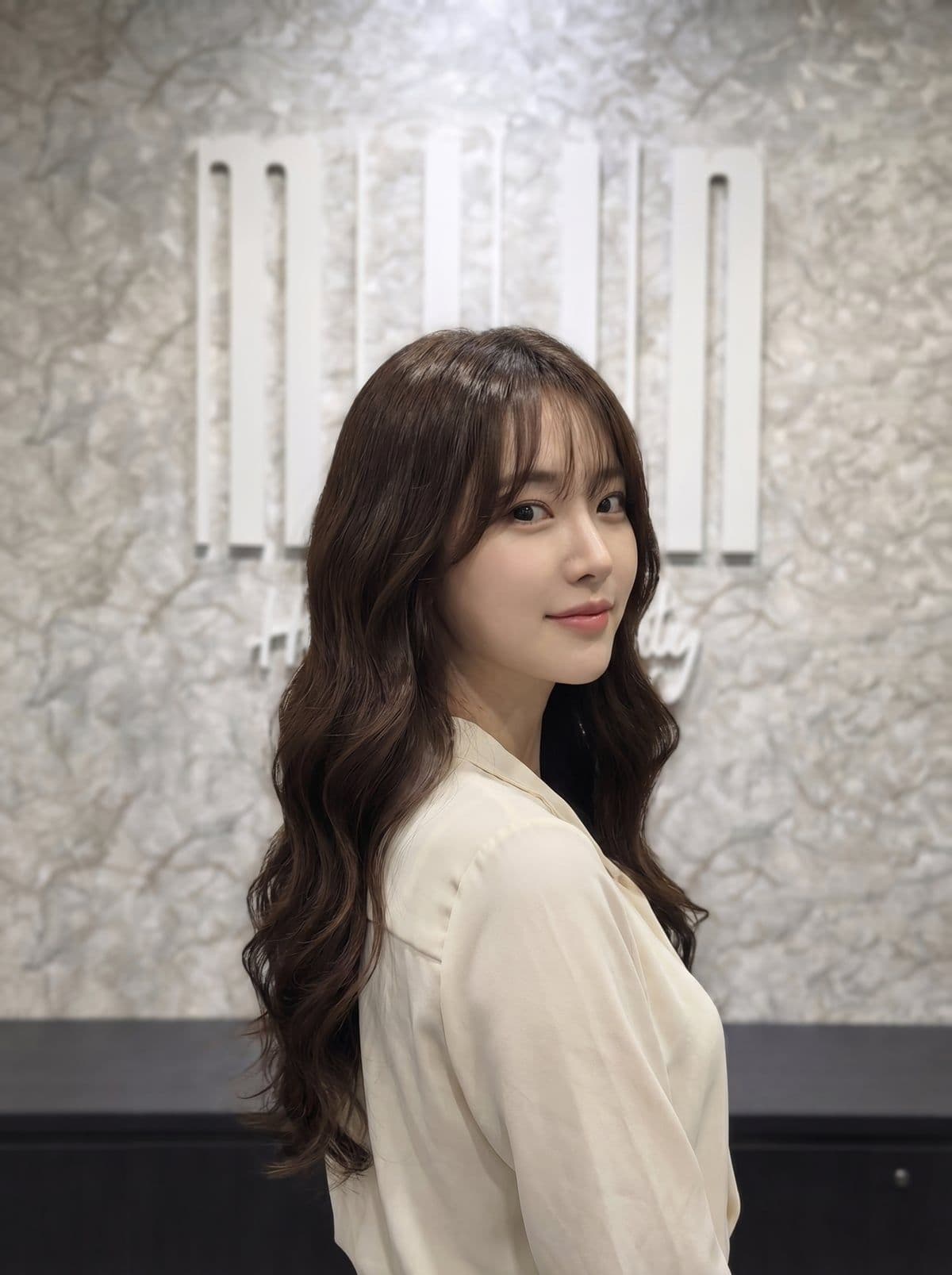 S-curl Korean digital perm — defined S-shaped waves throughout medium-long hair, styled at Miin salon Singapore