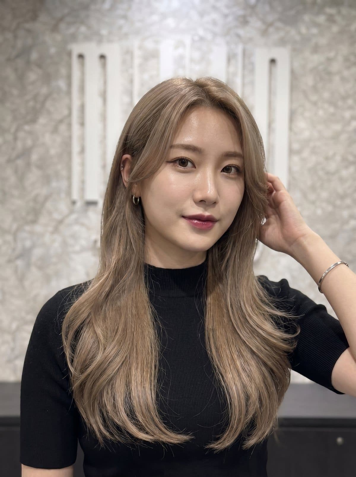 Milk tea hair color at Miin salon Singapore — creamy neutral light brown with warm beige undertones, a signature Korean bleached shade