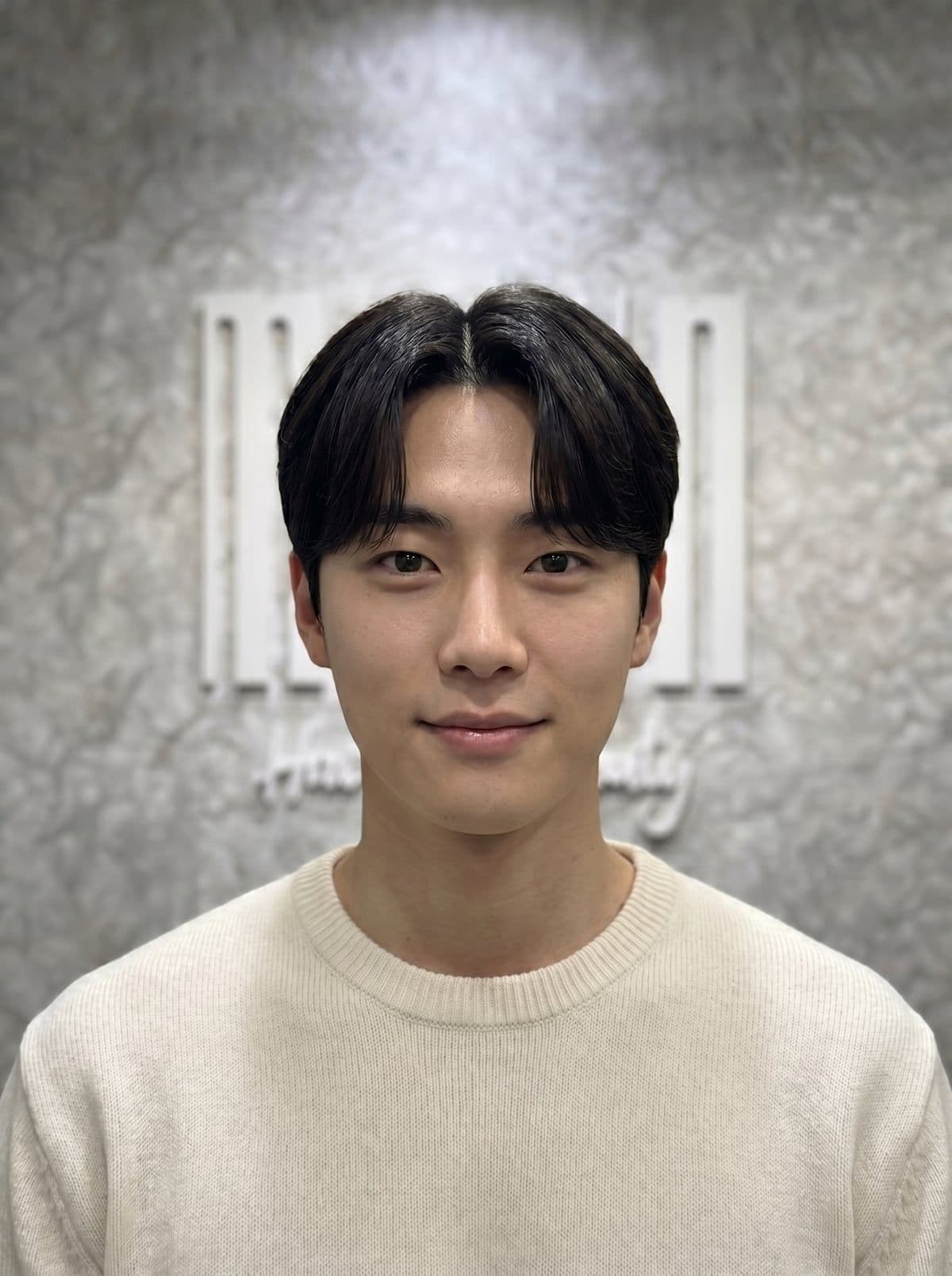Comma haircut — Korean men's middle part cut with curtain bangs and inward-curving fringe, layered scissor-cut styled at Miin salon Singapore