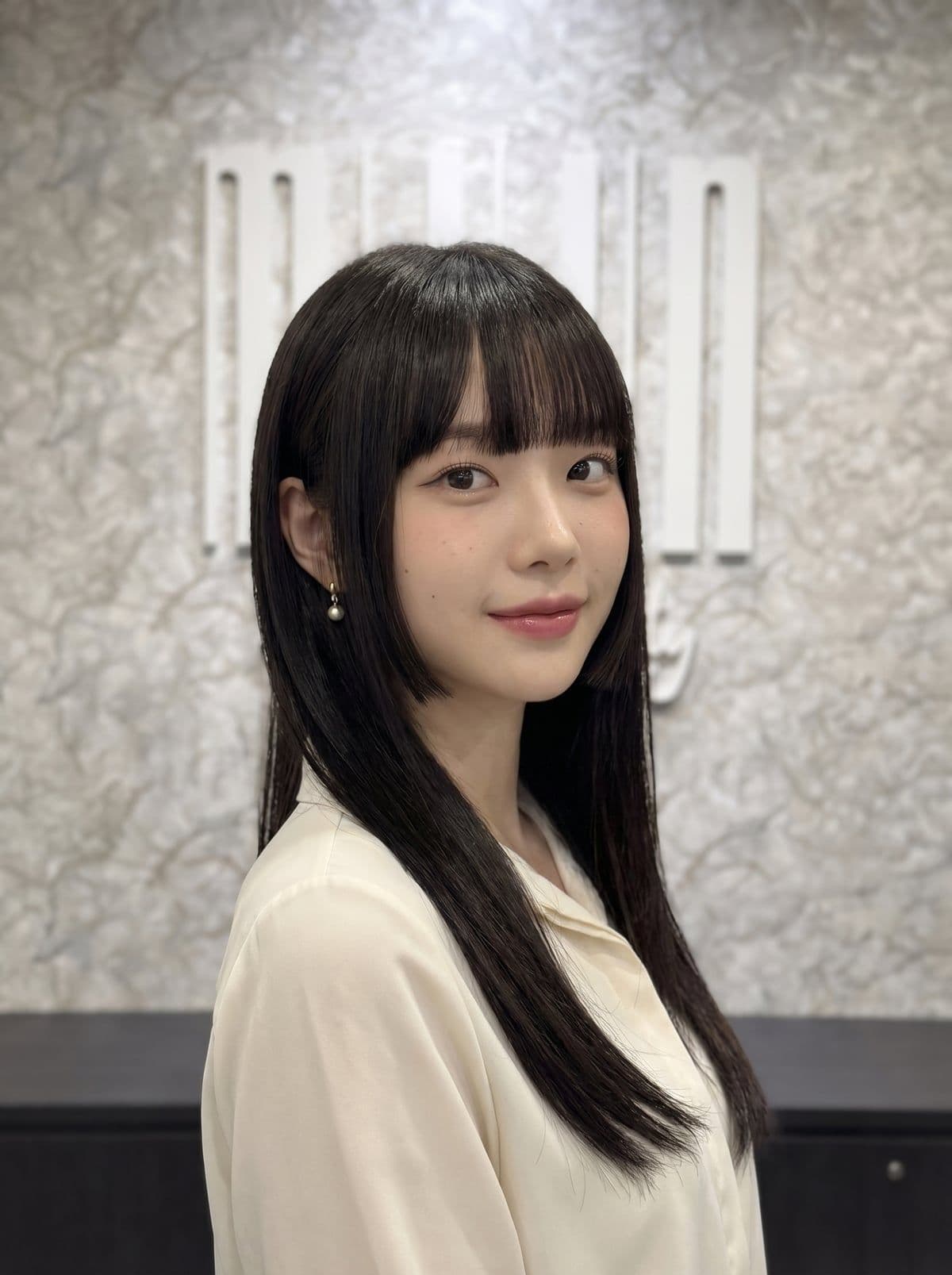 Hime cut — structured Korean haircut with full blunt straight-across bangs, sharp cheek-length face-framing pieces, and long straight back length, styled at Miin salon Singapore