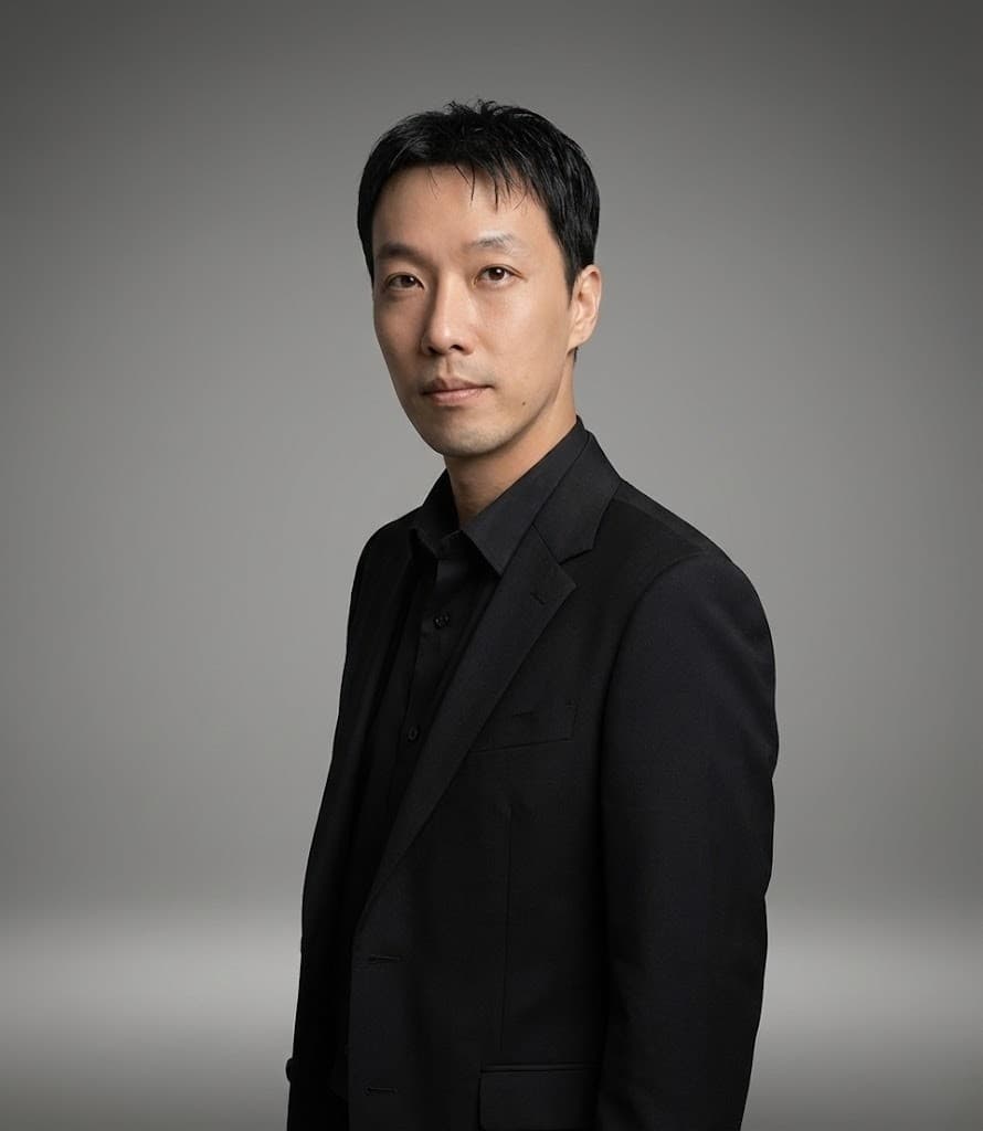 Pio, Creative Director at Miin Singapore wearing a black suit