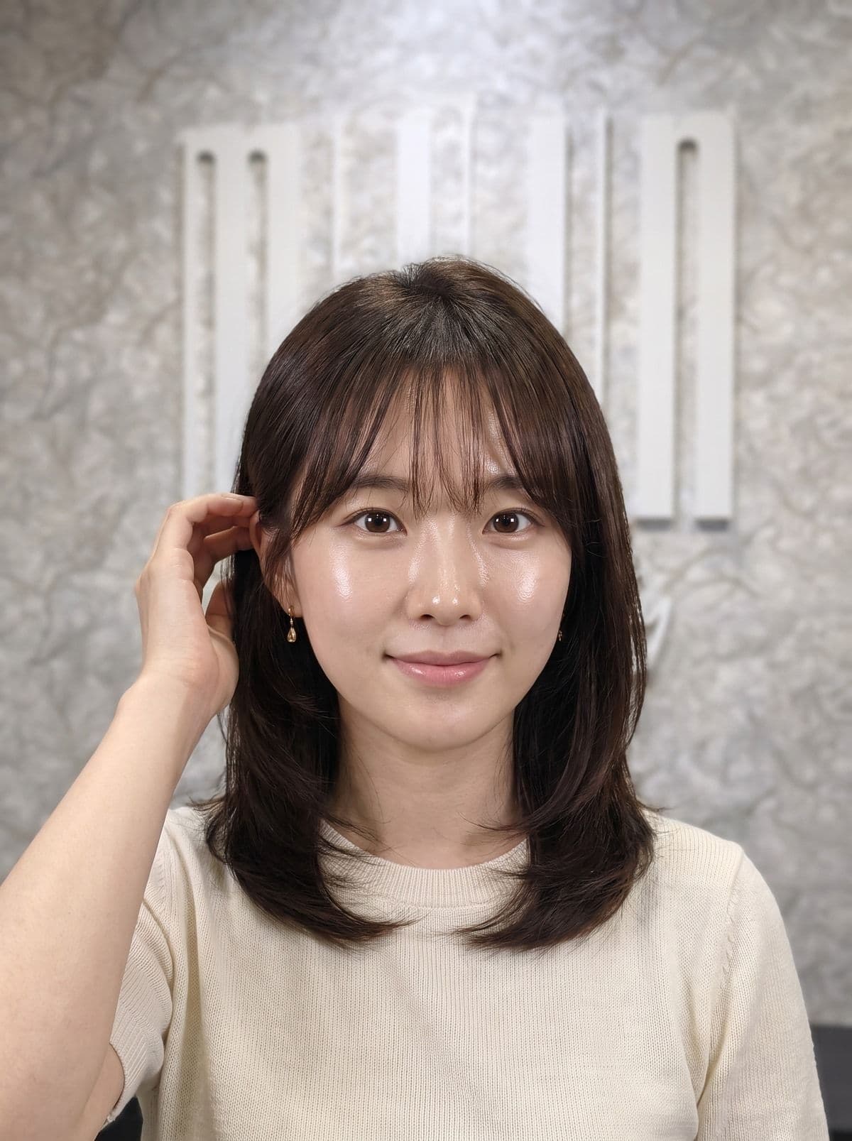 Korean hush cut — airy layers and wispy curtain bangs framing the face